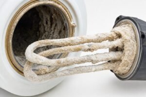 Thick mineral scale coating a water heater element removed from a tank