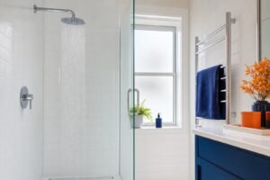 A clean modern bathroom shower running cold water